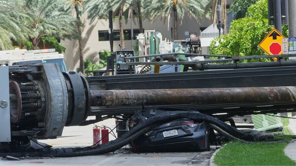 Four injured after 85-foot drill rig collapses onto car at Miami construction site